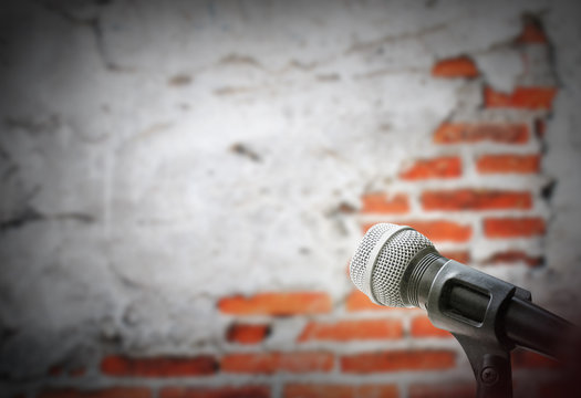 Microphone on brick wall background