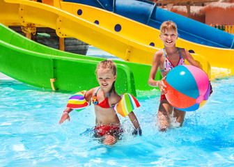 Child on water slide at aquapark.