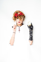  woman with red flowers in hair doing make-up