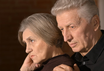 sad elder couple at home