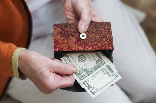 Seniorin schaut in ihre Geldboerse