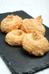 Coconut cookies on a black plate