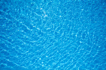 Fototapeta na wymiar Blue and Bright water surface in swimming pool