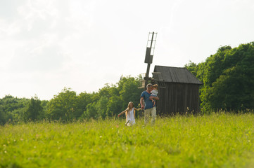 Dad with kids on the lawn.