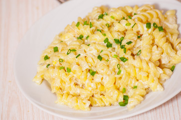 fusilli pasta in a creamy sauce.
