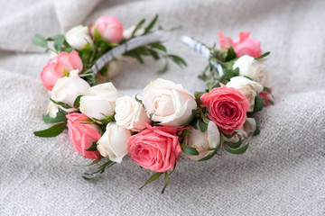 tiara of artificial roses on wooden background. © Elena Kharichkina