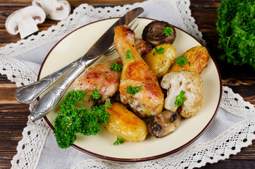 Baked chicken legs with potatoes, champignon and cauliflower