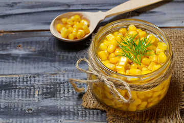 Canned sweet corn in wooden background