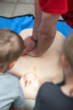 Man doing CPR on a mannequin for training