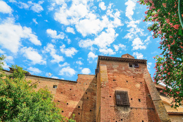 Fototapeta na wymiar antique brick wall under a cloudy sky in Siena