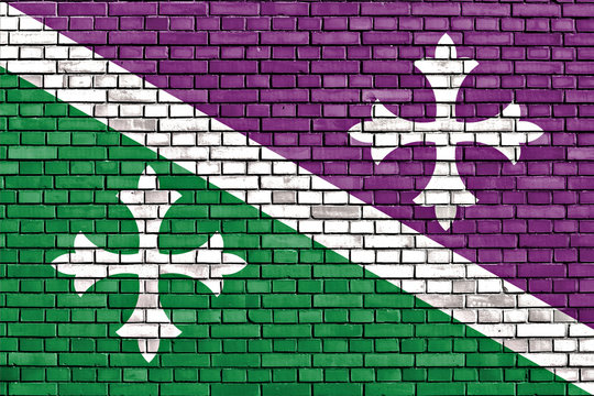 flag of Adjuntas painted on brick wall