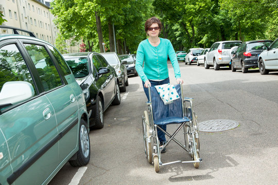 Caregiver pushes wheelchair