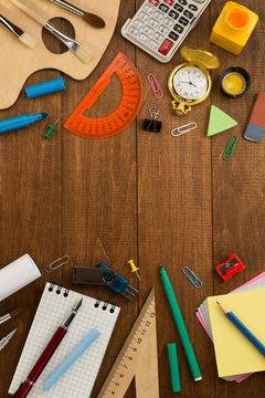 school supplies and notebook on wood