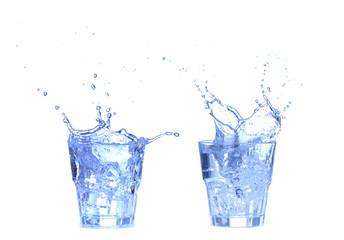 Glass of water, ice and slice of fresh lemon on a white background