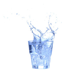 Glass of water, ice and slice of fresh lemon on a white background
