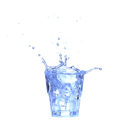 Glass of water, ice and slice of fresh lemon on a white background