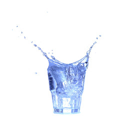 Glass of water, ice and slice of fresh lemon on a white background