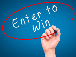 Man Hand writing Enter to Win with marker