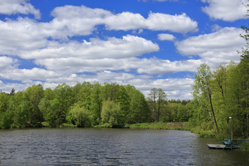 Obraz premium Blue sky with clouds, lake and forest