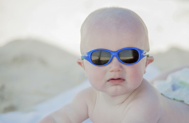 A baby is covered with sunscreen at the beach in Cancun, Mexico