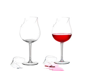 Two broken glass and empty with red wine on white isolate