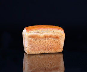 Bread on a black background with reflection