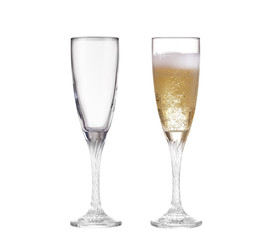 Full and empty champagne glasses with white wine