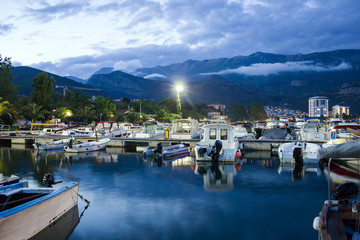 Fototapeta na wymiar Montenegro: Night view with boats on sea front of Budva 