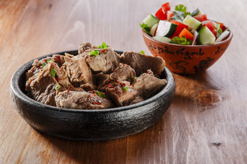 boiled meat in a clay bowl