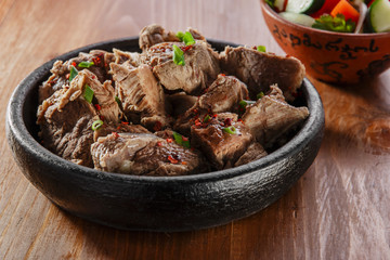 boiled meat in a clay bowl