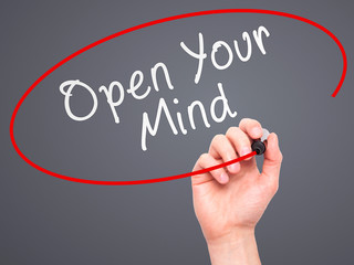Man hand writing Open Your Mind with marker on transparent 