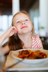 Little girl eating spaghetti