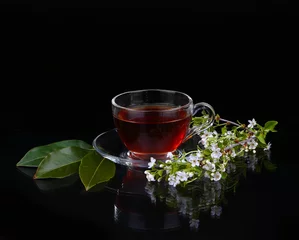 Fotobehang cup of tea and cherry branch © YURII Seleznov