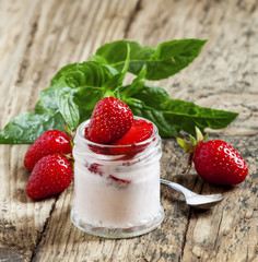 Homemade strawberry yogurt with fresh strawberries and mint in a