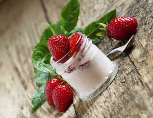 Homemade strawberry yogurt with fresh strawberries and mint in a