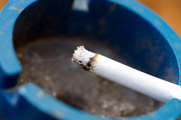 Cigarette / smoldering cigarette in an ashtray