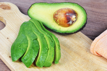 Avocado sliced on a wooden board