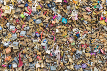 Love padlocks at bridge over river Seine in Paris, France