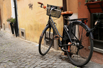 Fototapeta na wymiar Black classic bike on a Roman street