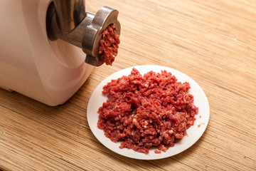 The electric meat grinder and forcemeat