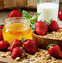 Jar of honey, strawberries, muesli, milk bottle, healthy eating