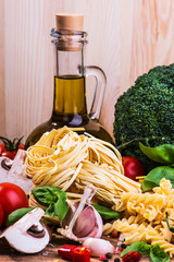 Pasta ingredients on a wood background
