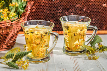 Tea with lime and honey in the garden at summer