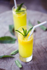 Orange drink on wooden table, selective focus