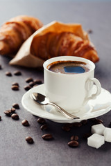 Fresh croissants  and cup of coffee on a table