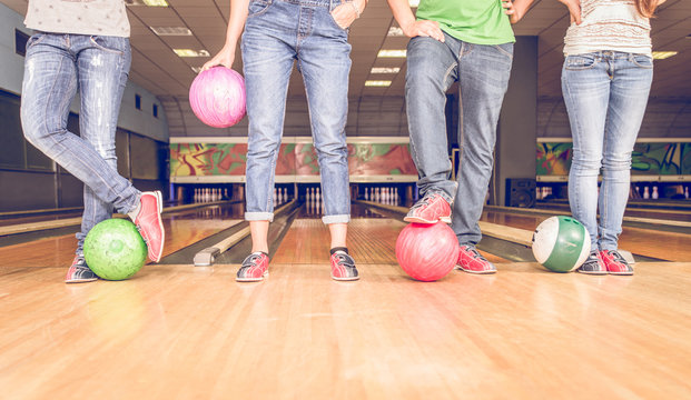 scene with four people and bowling balls
