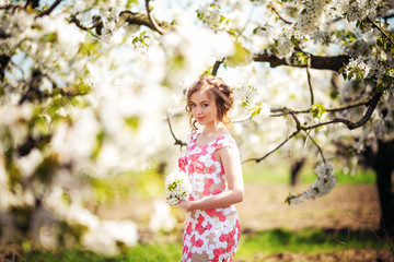 Beautiful young woman in spring garden