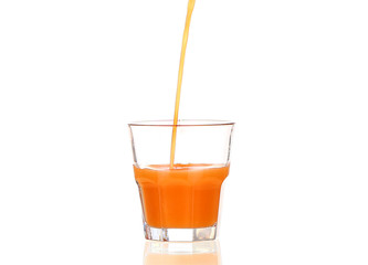 Juice pouring into glass isolated on white
