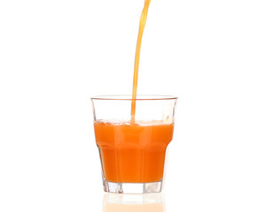 Juice pouring into glass isolated on white