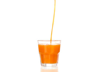 Juice pouring into glass isolated on white